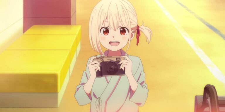 An even younger Chisato smiles with a camera in Lycoris Recoil.