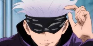 Satoru Gojo smirking with a blindfold on in Jujutsu Kaisen.