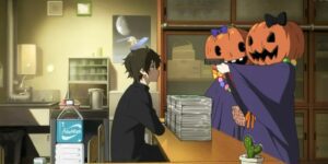 Girls dressed as pumpkins pointing a gun at Hotarou from Hyouka