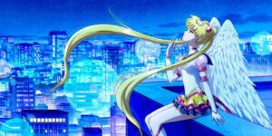 Usagi on the poster for Sailor Moon Cosmos sitting on the edge of a building looking up.
